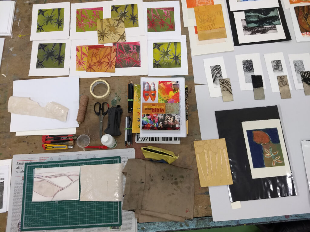 Overhead picture of a selection of course materials and final prints