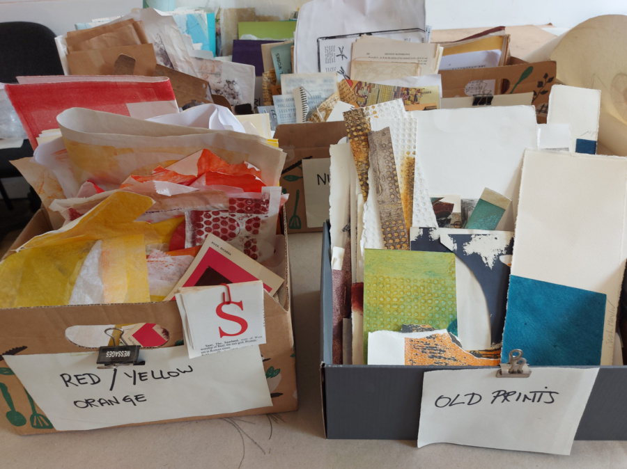 Boxes of coloured collage papers